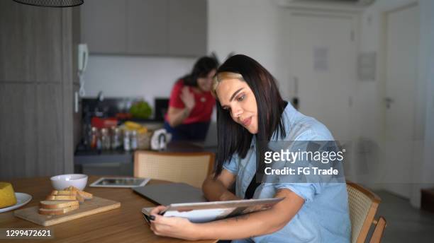 Transgender woman reading a book at home