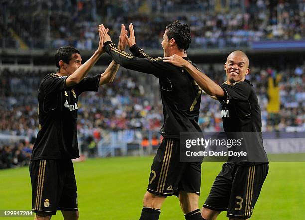 Cristiano Ronaldo of Real Madrid celebrates with Angel di Maria and Pepe after he scored his second goal during the La Liga match between Malaga CF...