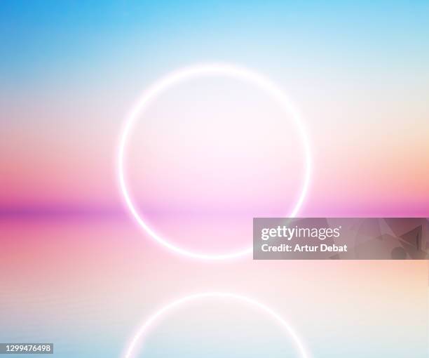 perfect neon ring glowing at sunrise sky levitating over the sea. - beautiful space bildbanksfoton och bilder