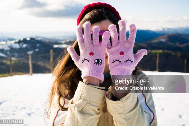 happy girl teenager in the snow - rosa handschuh stock-fotos und bilder