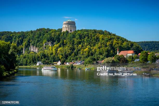 tourboat on danube river and befreiungshalle in background - regensburg stock pictures, royalty-free photos & images