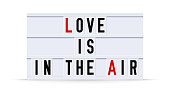 LOVE IS IN THE AIR text in a vintage light box. Vector illustration