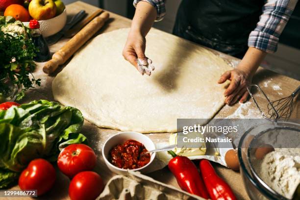 hands baking bread or pizza dough on wooden table ,spreading flour - arm made of vegetables stock pictures, royalty-free photos & images