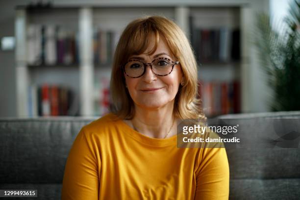 portrait of smiling senior woman at home - eastern european woman stock pictures, royalty-free photos & images