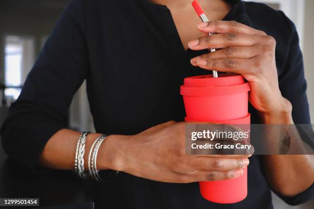 woman enjoys drink using reusable cup and straw - red straw stock pictures, royalty-free photos & images
