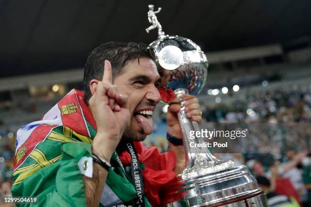 Coach of Palmeiras Abel Ferreira holds the Copa CONMEBOL Libertadores champions trophy after against Santos at Maracanã Stadium on January 30, 2021...
