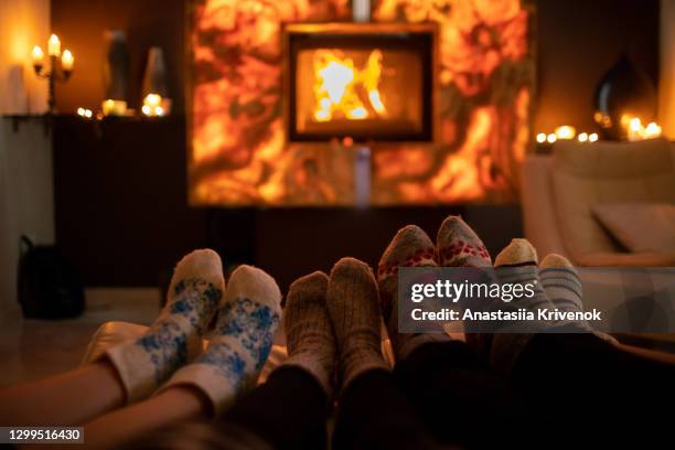 feet in wool socks near fireplace in winter time. - kids feet in home stock pictures, royalty-free photos & images