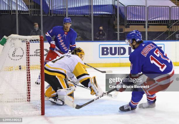 Kevin Rooney of the New York Rangers scores a second period goal against Casey DeSmith of the Pittsburgh Penguins on an assist from K'Andre Miller at...