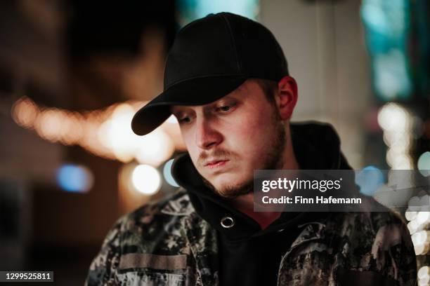 bugged young man in city street at night night out portrait - reflection night lights stock pictures, royalty-free photos & images