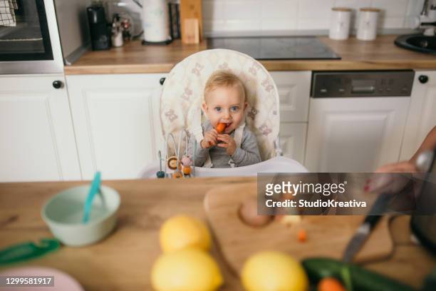young mother is feeding her baby - alleinerzieherin stock pictures, royalty-free photos & images
