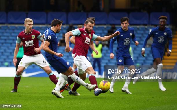 Cesar Azpilicueta of Chelsea scores their side's first goal whilst under pressure from Erik Pieters of Burnley during the Premier League match...