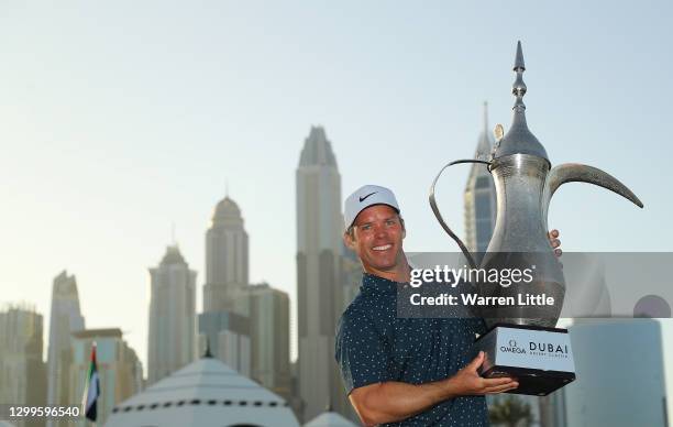 Paul Casey of England celebrates with the winners trophy after the final round of the Omega Dubai Desert Classic at Emirates Golf Club on January 31,...