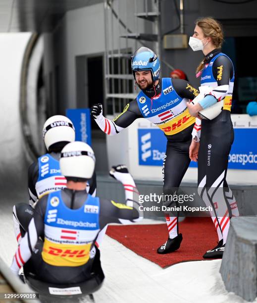 David Gleirscher and Madeleine Egle of Austria celebrate with Thomas Steu and Lorenz Koller after winning the team relay competition during day 3 of...