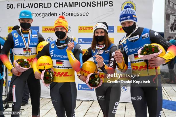 Toni Eggert, Sascha Benecken, Julia Taubitz and Felix Loch of Germany celebrate winning the silver medal in the team relay competition during day 3...