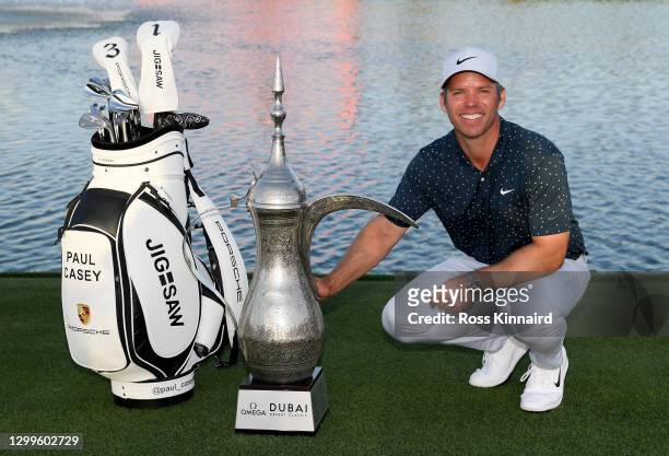 Paul Casey of England with the winners trophy on the 18th green after the final round of the Omega Dubai Desert Classic at Emirates Golf Club on...