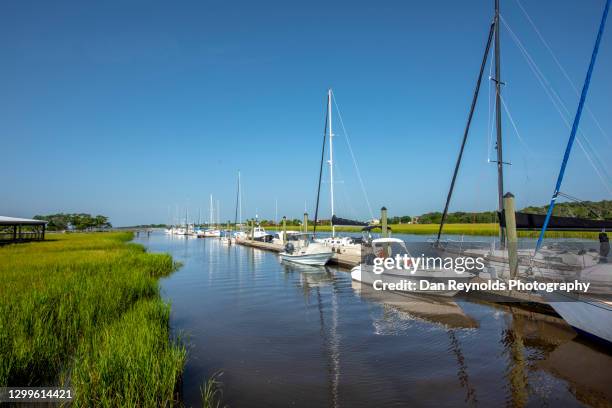 sail boats moored at harbor against blue sky - amelia island florida stockfoto's en -beelden
