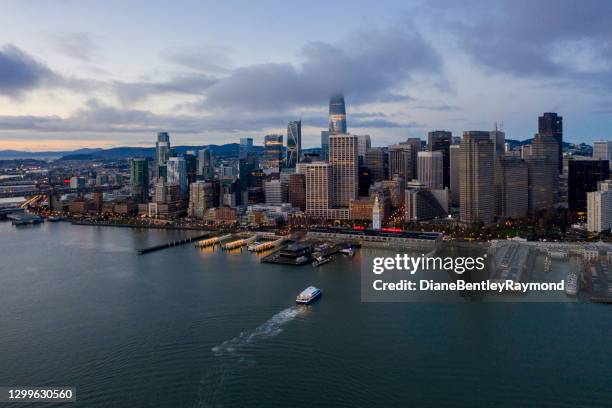 aerial view of ferry and san francisco skyline - ferry terminal stock pictures, royalty-free photos & images