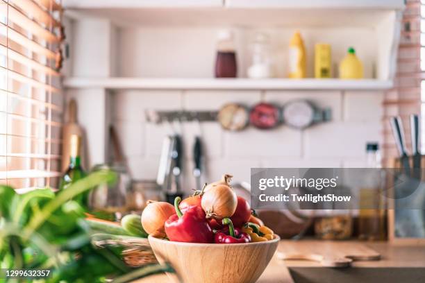 Fresh seasonal vegetables in warm kitchen light