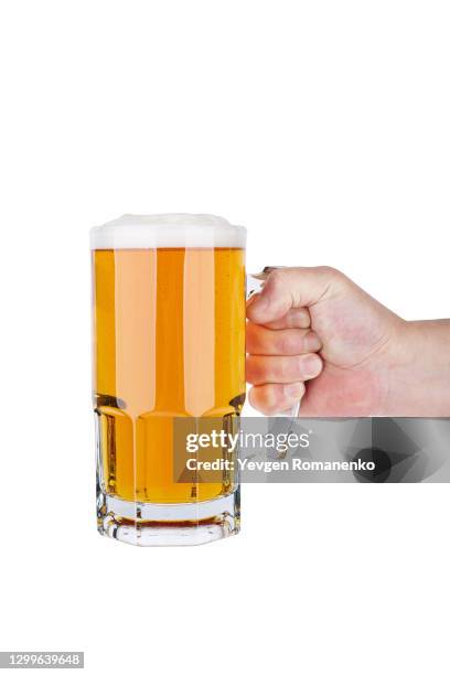 glass of light beer in mens hand isolated on a white background - boccale da birra di ceramica foto e immagini stock