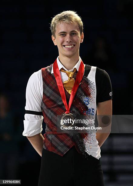 Michal Brezina of the Czech Republic stands with his gold medal after winning the men's competition during Hilton HHonors Skate America at Citizens...