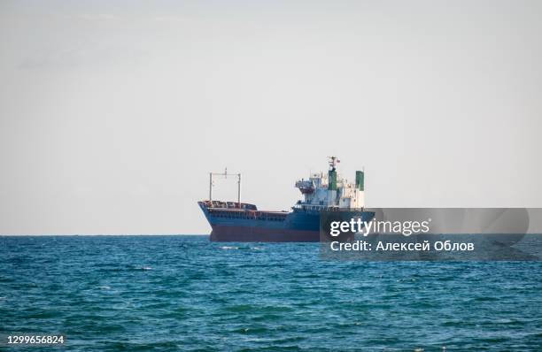 big cargo ship waiting in line to enter the port - tanker ship stock pictures, royalty-free photos & images