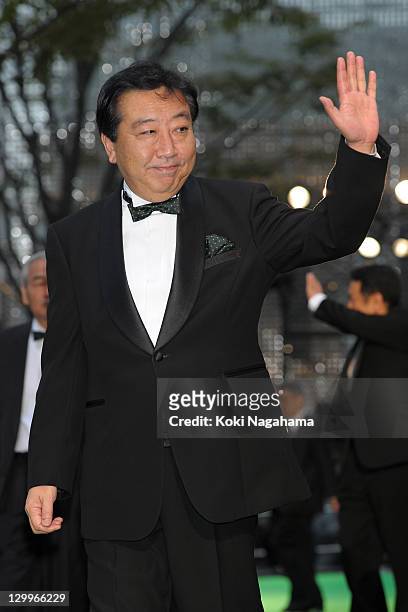 Japanese Prime Minister Yoshihiko Noda waves on the green carpet during the Tokyo International Film Festival Opening Ceremony at Roppongi Hills on...