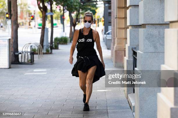 Member of the public is seen wearing a face mask and exercising in the Central Business District February 01, 2021 in Perth, Australia. Lockdown...