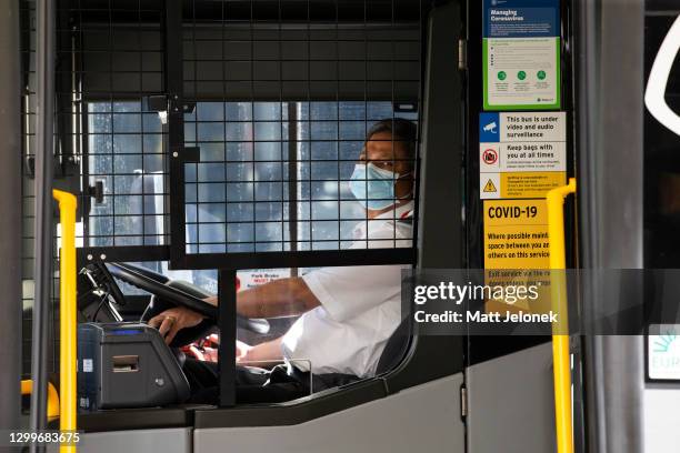Bus driver is seen wearing a face mask in the Central Business District on February 01, 2021 in Perth, Australia. Lockdown restrictions are now in...