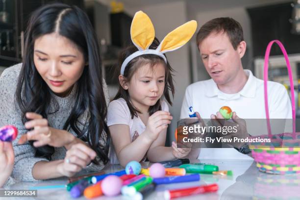 family preparing an easter basket - easter bunny man stock pictures, royalty-free photos & images