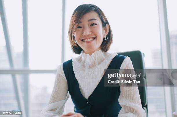 asian chinese beautiful woman looking at camera videocall smiling indoor - camera operator stock pictures, royalty-free photos & images