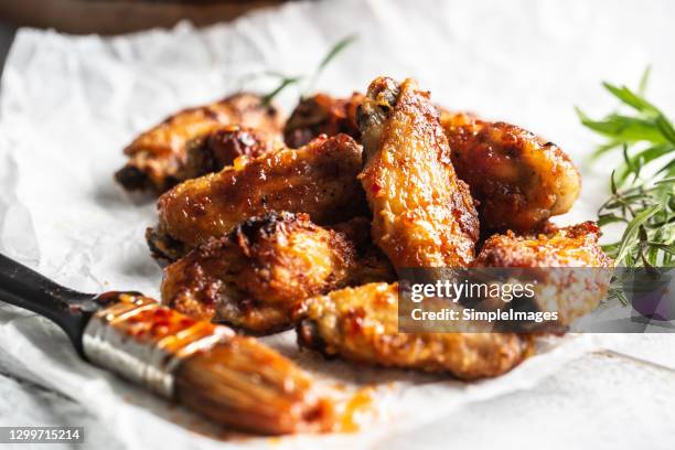 roasted chicken wings in barbecue sauce and rosemary. - buffalo chicken stock pictures, royalty-free photos & images