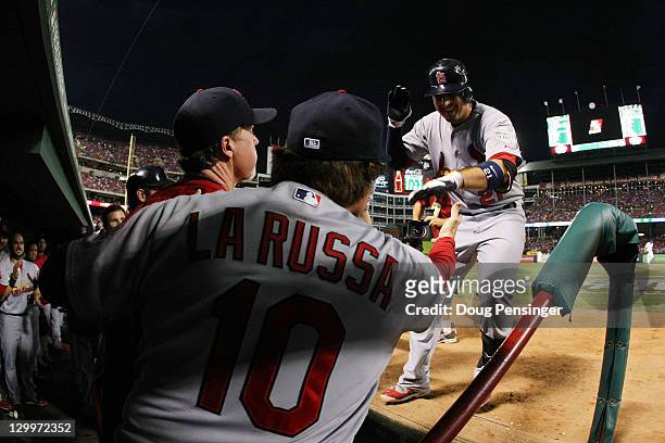 Allen Craig of the St. Louis Cardinals celebrates back in the dugout after hitting a homerun in the first inning during Game Three of the MLB World...