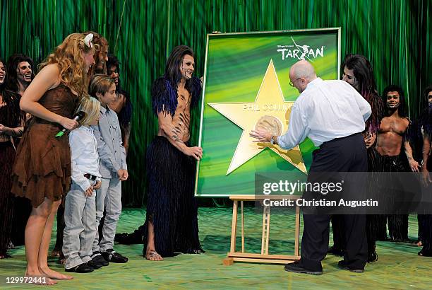 Phil Collins and both sons Matthew Collins and Nicholas Collins, Elisabeth Huebert and Alexander Klaws are watching a handprint honouring Phil...