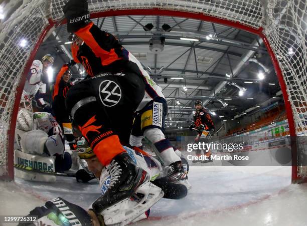 Eric Mik of Eisbären Berlin slides into the net during the Deutsche Eishockey Liga DEL match between Grizzlys Wolfsburg and Eisbären Berlin at...