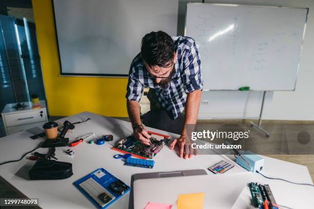 young man soldering - flexible printed circuit board stock pictures, royalty-free photos & images