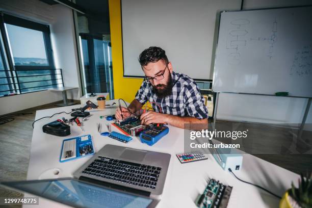 young man soldering - flexible printed circuit board stock pictures, royalty-free photos & images