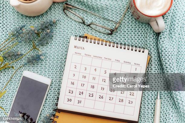 march calendar  in feminine workspace with lavender flowers, coffee , eyeglasses and pen - equinox stock pictures, royalty-free photos & images
