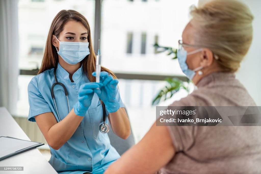 Female doctor giving a consultation to a senior patient