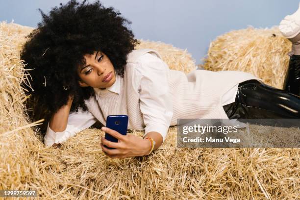woman taking a selfie with phone on a straw bale. - agriculteur selfie photos et images de collection