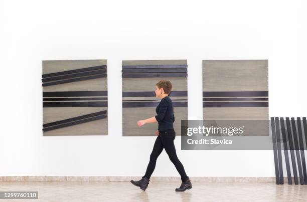 female artist assembling installation art - modern art gallery stock pictures, royalty-free photos & images