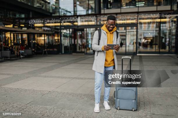 young man ready to travel - yellow suitcase stock pictures, royalty-free photos & images