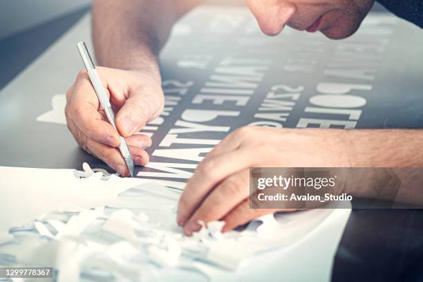 cutting self-adhesive foil. - craft knife stock pictures, royalty-free photos & images