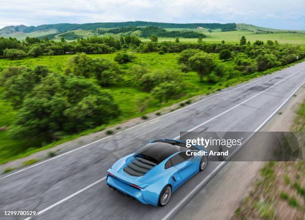 blue sportscar driving on a country road - mountain road stock pictures, royalty-free photos & images