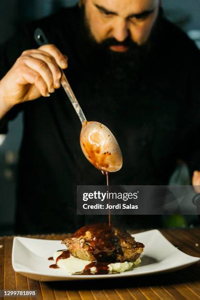 chef preparing beef cheeks with porto sauce - porto portugal food stock pictures, royalty-free photos & images