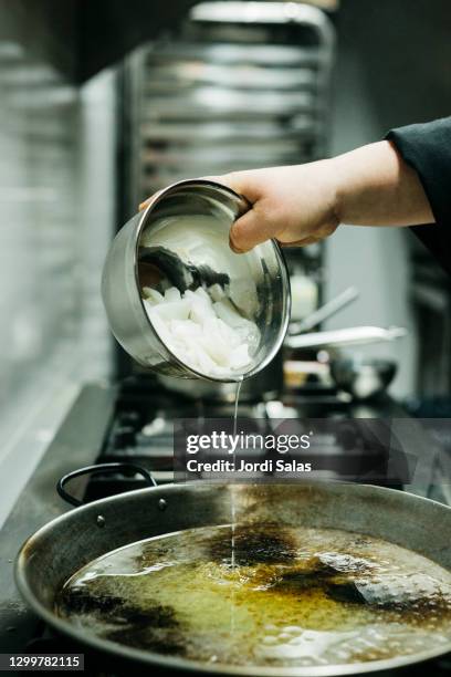 chef pouring squid in a pan - chopping stock pictures, royalty-free photos & images