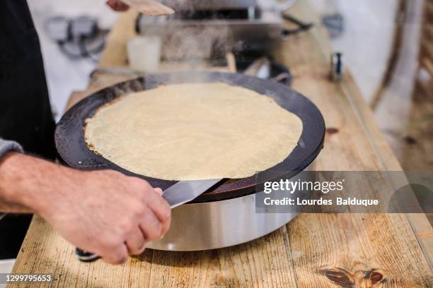 galette preparation in a restaurant - crepes stock-fotos und bilder