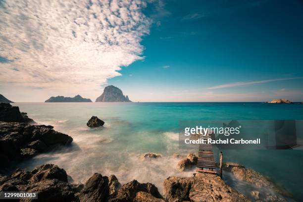 view of es vedrá islet from cala d´hort beach. - ibiza strand stock pictures, royalty-free photos & images