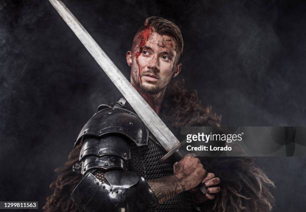portrait of a bloodied young black knight prince in armour - bad actor stock pictures, royalty-free photos & images