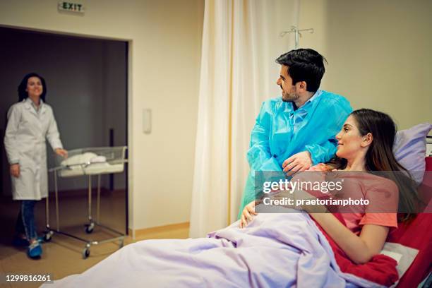 couple is waiting in hospital delivery room for their newborn baby - delivery room stock pictures, royalty-free photos & images