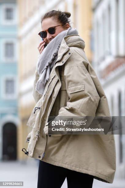 Fashion designer Eva Lutz wearing a beige jacket by Balenciaga, black pants by Balenciaga, a grey scarf by Pur schoen and brown vintage...